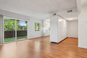Spare room with light wood finished floors, baseboards, and a sink