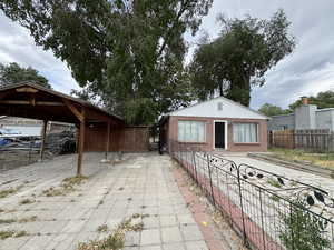View of patio with fence and a carport