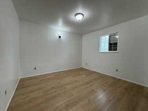 Unfurnished room with light wood-style flooring and baseboards