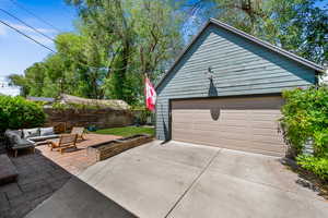 Garage with fence and concrete driveway