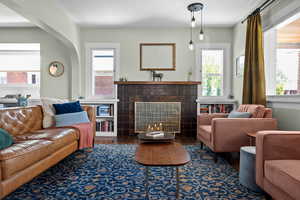 Living area with a tile fireplace and healthy amount of natural light