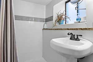 Bathroom with a sink and tiled shower