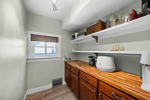 Bar area featuring baseboards and wood tiled floors