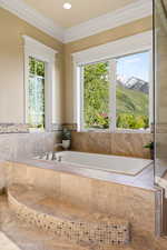 Bathroom with plenty of natural light, ornamental molding, a garden tub, and recessed lighting