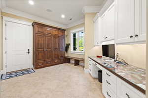 Office with built in study area, baseboards, ornamental molding, and recessed lighting