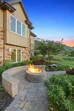 View of patio / terrace featuring an outdoor fire pit and a mountain view