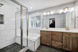 Full bathroom with a stall shower, a bath, tile patterned floors, double vanity, and recessed lighting
