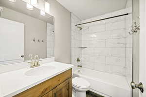 Full bathroom with toilet, shower / washtub combination, and vanity