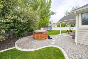 View of yard with a trampoline and a patio area