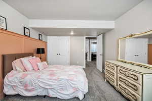 Bedroom featuring light colored carpet and a closet