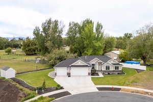 View of front of home with an attached garage and driveway