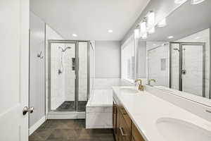 Bathroom with a shower stall, recessed lighting, a garden tub, and double vanity