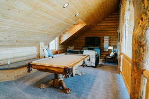 Game room with log walls, wooden ceiling, carpet flooring, pool table, and lofted ceiling
