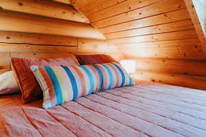 Bedroom featuring wood walls