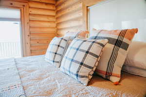 Bedroom featuring rustic walls