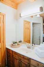 Bathroom featuring a shower stall and vanity