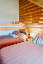 Bedroom with rustic walls