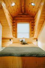 Bedroom featuring rustic walls, lofted ceiling, recessed lighting, and wooden ceiling