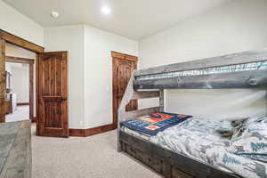Bedroom featuring carpet flooring and baseboards