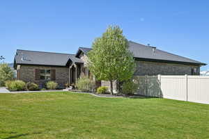 View of front facade with brick siding and roof with shingles