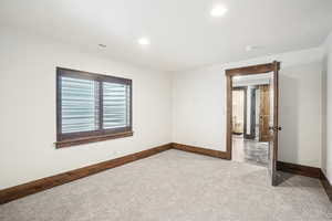 Unfurnished room with baseboards, carpet floors, a smoke detector, and recessed lighting