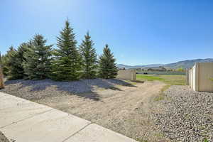 View of yard with fence and a mountain view