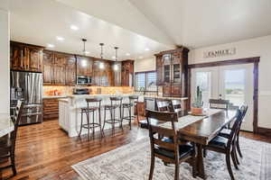Dining space with recessed lighting, wood-type flooring, french doors, and lofted ceiling