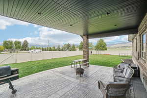View of patio / terrace with a mountain view and an outdoor fire pit