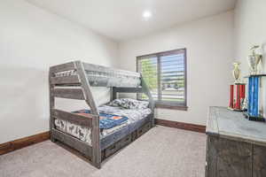 Bedroom with carpet flooring, baseboards, and recessed lighting