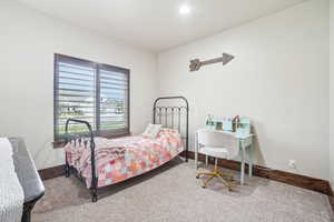 Carpeted bedroom with baseboards