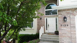 View of exterior entry featuring brick siding