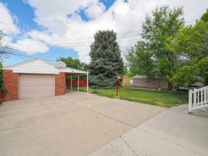 Garage featuring concrete driveway