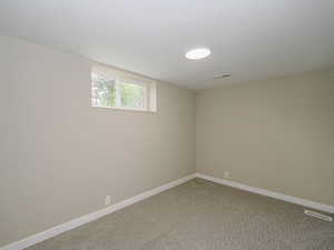 Empty room with baseboards and carpet floors