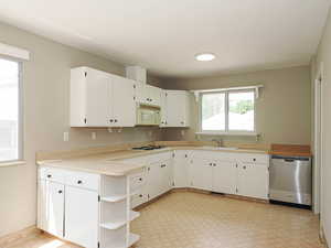 Kitchen featuring white appliances, open shelves, a sink, and white cabinetry