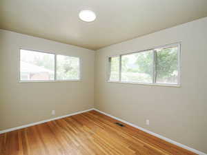 Unfurnished room featuring baseboards and light wood-style flooring