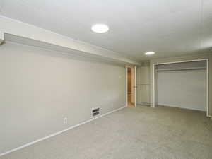 Unfurnished bedroom featuring carpet, baseboards, and a closet