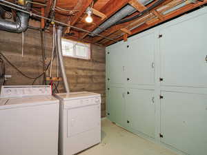 Laundry room with cabinet space and washer and clothes dryer