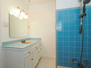 Full bath with tile patterned floors and vanity