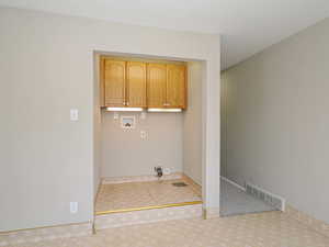 Washroom featuring cabinet space, washer hookup, and carpet floors