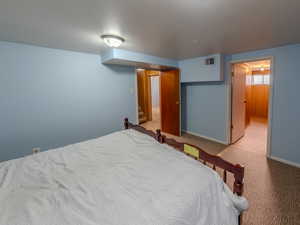 Carpeted bedroom featuring baseboards