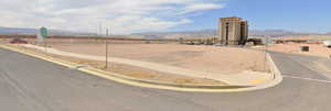 View of asphalt street featuring curbs and a mountain view