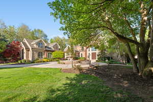 View of front facade featuring stone siding and a front yard