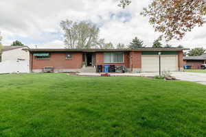 Single story home with brick, a garage, driveway, and entry steps