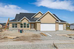 View of front of property with a garage, board and batten siding, and a shingled roof