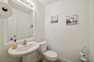 Half bathroom featuring toilet and a sink