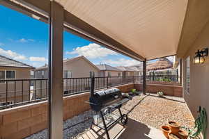 View of patio featuring a residential view, a fenced backyard, and area for grilling