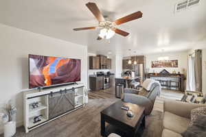 Living area with a chandelier and a ceiling fan