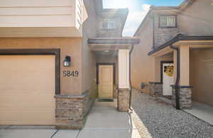 Property entrance with stucco siding and stone siding