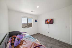 Carpeted bedroom featuring baseboards and recessed lighting