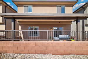 Back of property featuring fence and stucco siding